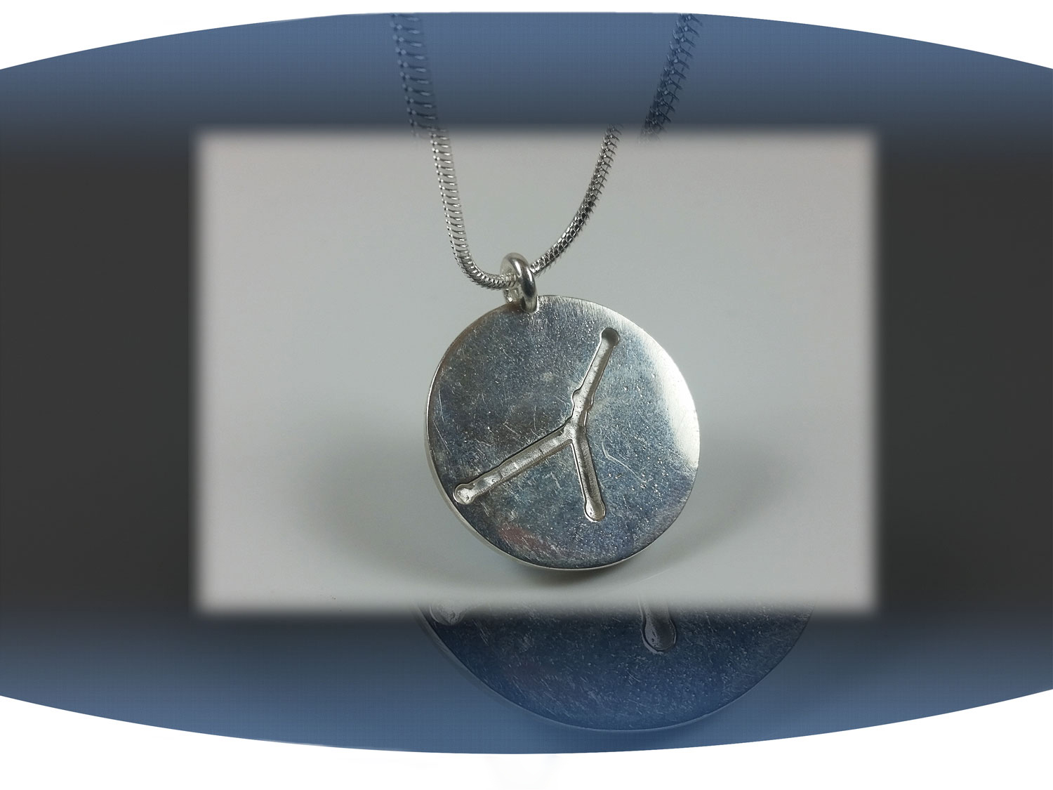 Close up of back of cancel zodiac pendant showing aquarius star constellation