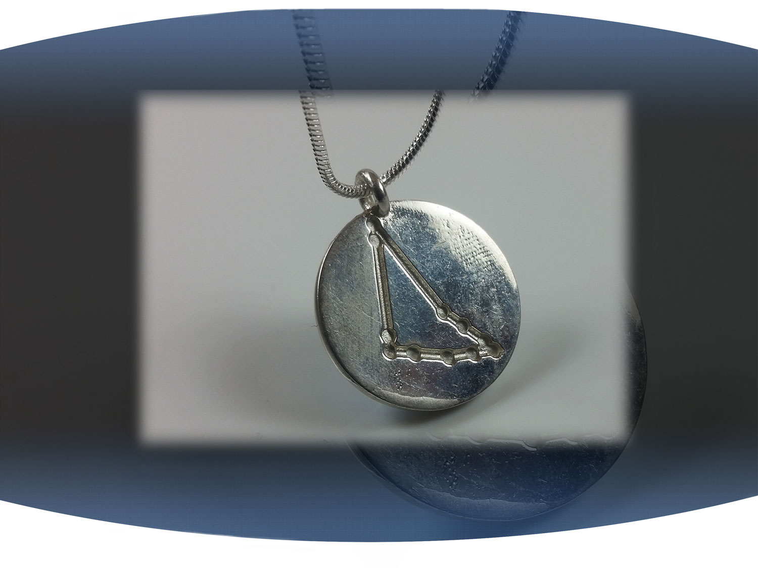 Close up of back of capricorn zodiac pendant showing aquarius star constellation