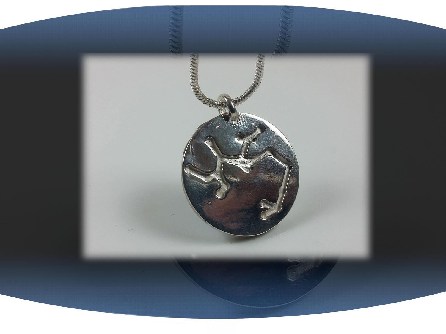 Close up of back of sagittarius zodiac pendant showing aquarius star constellation