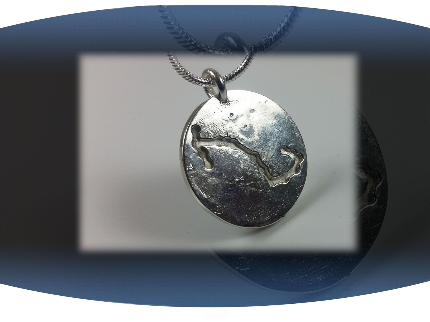 Close up of back of a scorpio zodiac pendant showing aquarius star constellation