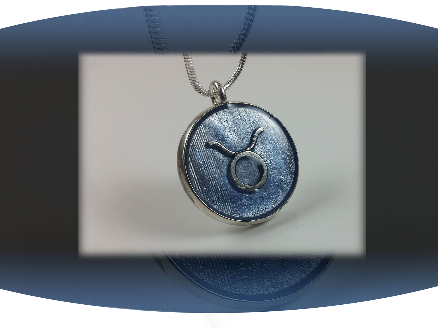 Sterling silver zodiac sign  taurus pendant with light blue resin and star constellation on the back