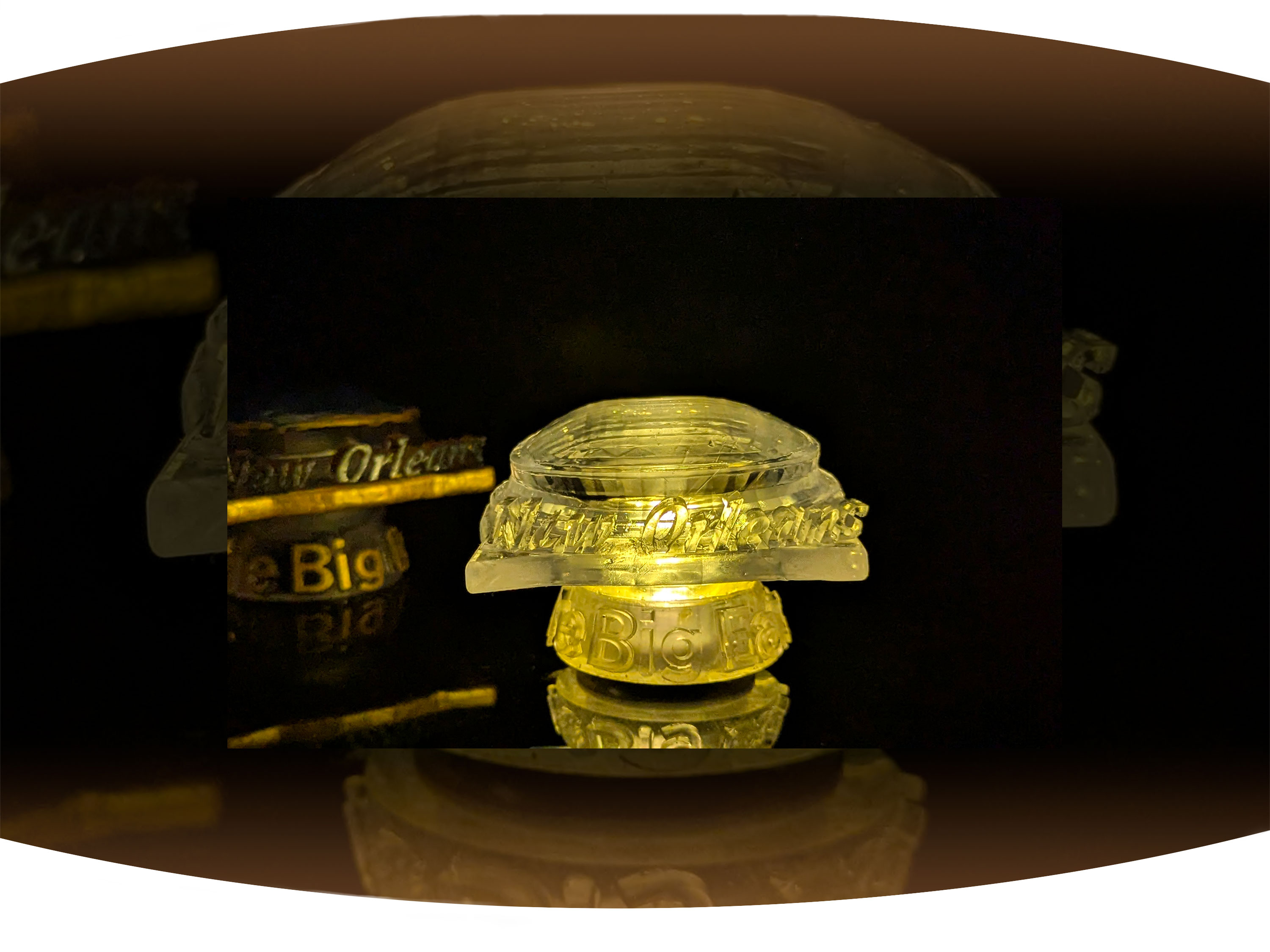 Close up of white screen printed  t-shirt with the black text Bywater with red stamp across it that says gentrified